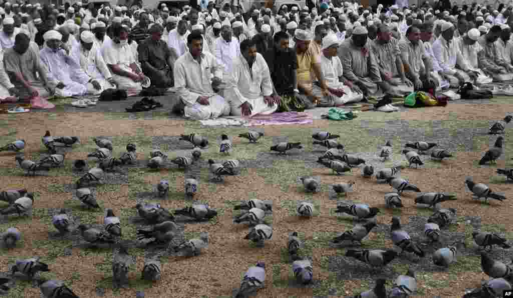 Muslim pilgrims pray outside the Grand Mosque in Mecca, Saudi Arabia, October 23, 2012.