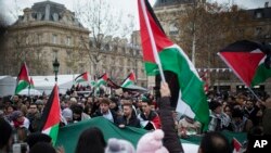 Demonstrators shout as they hold Palestinian flags during a protest against U.S. President Donald Trump's decision to recognize Jerusalem as Israel's capital, at Republique Square in Paris, France, Dec. 9, 2017.