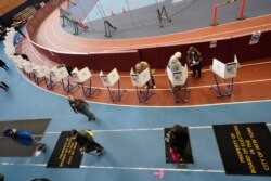 Voters mark their ballots during early voting at the Park Slope Armory YMCA, Oct. 27, 2020, in the Brooklyn borough of New York.