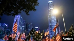 FILE - Protesters hold U.S. flags during a gathering at Edinburgh Place in Hong Kong, China, Nov. 28, 2019. 