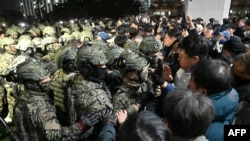 FILE - Soldiers try to enter the National Assembly building in Seoul on Dec. 4, 2024, after South Korea President Yoon Suk Yeol declared martial law on December 3.