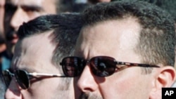 Bashar al-Assad (R) and his younger brother Maher al-Assad, (File)