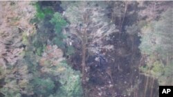 This photo released by the National Search and Rescue Agency (BASARNAS) of Indonesia shows the part of the wreckage that BASARNAS identified as of the missing Trigana Air Service flight that crashed in Oksibil, Papua, Aug. 17, 2015. 