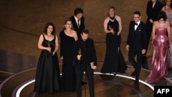 Ukrainian filmmaker Mstyslav Chernov (C) accepts the award for Best Documentary Feature Film for "20 Days in Mariupol" onstage during the 96th Annual Academy Awards at the Dolby Theatre in Hollywood, California on March 10, 2024.