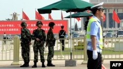 Armed Chinese police stand guard on Tiananmen Square in Beijing, June 3, 2014. 
