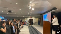 Denise Frazier, Atlanta district director for U.S. Citizenship and Immigration Services, administers the oath of allegiance to 99 new American citizens gathered at The Carter Center, Sunday, Oct. 1, 2023, in Atlanta, on former President Jimmy Carter's 99th birthday.