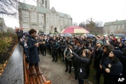 Students at Boston College listen to a speaker as they gather during a solidarity demonstration on the school's campus, in Newton, Mass., Nov. 12, 2015.