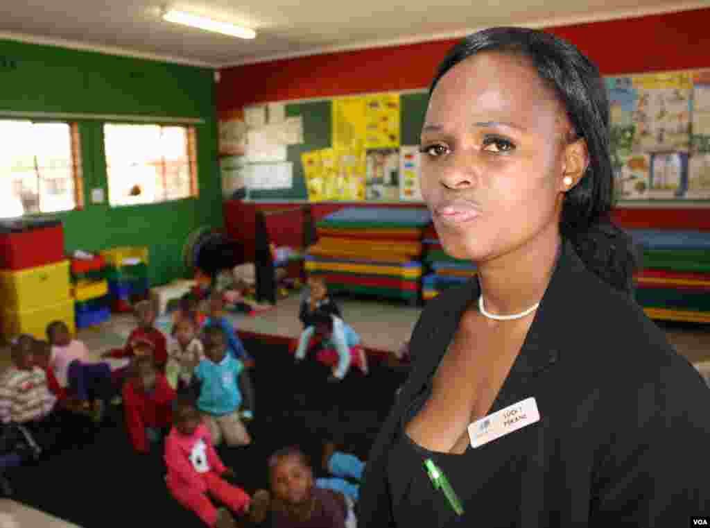 In their art, Pekane sees visual hints of problems some of the children experience at home: &nbsp;blood flowing in a red stream from a figure spread-eagled on grass, another holding what looks like a jagged knife.&nbsp;(Photo by Darren Taylor)