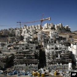 Houses under construction are seen in a Jewish settlement near Jerusalem known to Israelis as Har Homa and to Palestinians as Jabal Abu Ghneim, 08 Dec 2010