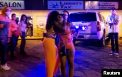 A woman reacts after shots were fired in a police officer-involved shooting in Ferguson, Aug. 9, 2015.
