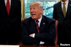 U.S. President Donald Trump talks to reporters about the killing of journalist Jamal Khashoggi in Turkey during a bill-signing ceremony at the White House in Washington, Oct. 23, 2018.