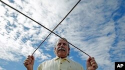 Marc Mondavi mendemonstrasikan "dowsing" untuk menemukan lokasi sumber air di tempat pembuatan anggur Charles Krug di St. Helena, California. 