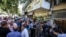 Iranians line up outside a currency exchange shop in Tehran in this recent photo published by Iran’s Fars news agency.