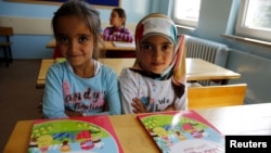 FILE - Syrian refugee children are seen in their classroom at Fatih Sultan Mehmet School in the Karapurcek district of Ankara, Turkey, Sept. 28, 2015.