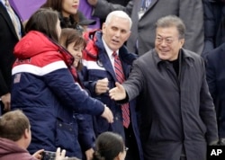United States' Vice President Mike Pence and South Korean President Moon Jae-in attend the ladies' 500 meters short-track speedskating in the Gangneung Ice Arena at the 2018 Winter Olympics in Gangneung, South Korea, Feb. 10, 2018.