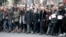 Charlie Hebdo magazine staff, with cartoonist Renald Luzier, known as Luz, front third left with mustache, march with relatives, right, of Jewish victim of the koscher supermarket, Michel Saada, in Paris, Jan. 11, 2015.