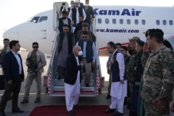 In this handout picture taken on Aug. 11, 2021, and released by the president's press office, Afghanistan's President Ashraf Ghani, center, arrives at Mazar-i-Sharif. (Press Office of President of Afghanistan / AFP)