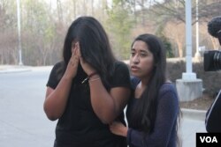 Edith Galvan, an undocumented immigrant and DACA recipient, offers support to Alisha Marcial during a vigil in honor of Marcial’s father. The father of seven U.S.-born children is detained at a county jail in Raleigh, North Carolina. (Photo: A. Barros / VOA)