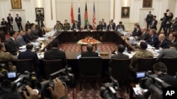 FILE - Delegations from Afghanistan, Pakistan, China and the United States discuss a roadmap for ending the war with the Taliban, at the Presidential Palace in Kabul, Afghanistan, Jan. 18, 2016.
