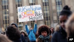A man holds a placard reading, "I am Nigerian. Stop Boko Haram," during a protest in Paris against extremist Islamic group Boko Haram, Jan. 18, 2015.