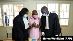 Le héros du film "Hôtel Rwanda", Paul Rusesabagina (au centre) avec son équipe de la défense à la Cour de justice de Nyarugenge à Kigali, au Rwanda, le 2 octobre 2020.