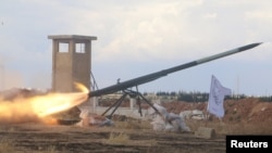 Rebel fighters from the First Regiment, part of the Free Syrian Army, fire a Grad rocket from Aleppo's al-Haidariya neighborhood, towards forces loyal to Syria's President Bashar al-Assad stationed in Talet al-Sheikh Youssef, Syria, May 29, 2016. 