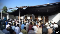 Afghan refugees offer Eid al-Adha prayers at a mosque in the Kazana Refugee camp on the outskirts of Peshawar, Pakistan, July 20, 2021. 