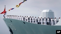 FILE - China's frigate Huangshan is seen anchored in the waters off RSS Singapura Changi Naval Base, May 15, 2017, in Singapore. 