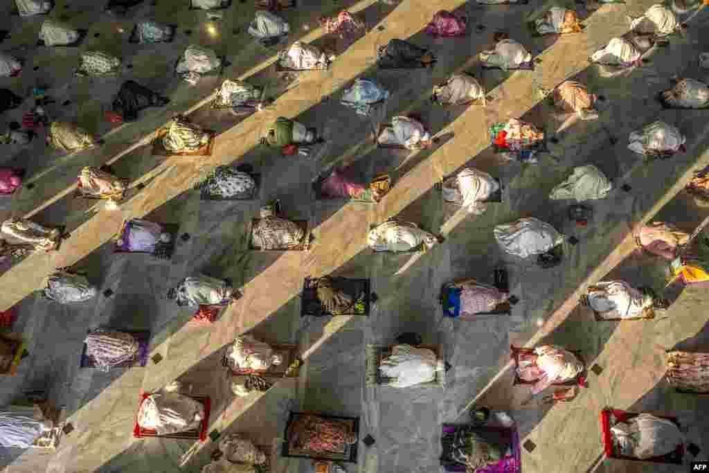 Muslims attend Eid al-Adha prayers with social distancing as a preventive measure against the COVID-19 coronavirus at a mosque in Surabaya in East Java, Indonesia.