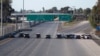 FILE - California Highway Patrol police cars block the highway leading from Mexico into San Diego after the border between Mexico and the U.S. was temporarily closed in the San Ysidro neighborhood of San Diego, California, Nov. 25, 2018.