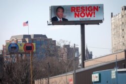 An electronic billboard displays a message urging New York Gov. Andrew Cuomo to "Resign Now" in the wake of allegations that he sexually harassed young women, in Albany, N.Y., March 3, 2021.