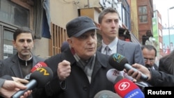Retired General Cetin Dogan (C) speaks to the media before surrendering himself at a courthouse in Istanbul, February 14, 2011.
