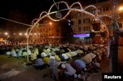 Men attend an evening mass prayer session called tarawih along a road to mark the fasting month of Ramadan in Karachi, Pakistan, May 27, 2017.