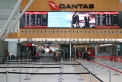 FILE - A mostly empty domestic terminal at Sydney Airport is seen after surrounding states shut their borders to New South Wales, in Sydney, Australia, Dec. 21, 2020.