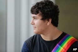 Boy Scout David Fite, 15, watches a Gay Pride party for youth at the Center on Halsted in Chicago, June 17, 2015.