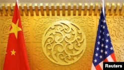FILE - Chinese and U.S. flags are set up for a meeting at China's Ministry of Transport in Beijing, April 27, 2018. 