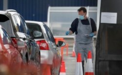 Staff work at a the COVID-19 testing facility at Ikea near the Wembley stadium in London, April 29, 2020.