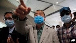 Hong Kong businessman and media tycoon Jimmy Lai, center, leaves a court after the court has found him not guilty in a case accusing him of criminal intimidation in Hong Kong, Sept. 3, 2020.