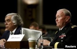 Chairman of the Joint Chiefs of Staff U.S. Army General Martin Dempsey, right, along with Energy Secretary Ernest Moniz, left, appear before the Senate Armed Services Committee in Washington, July 29, 2015.