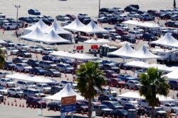 Motorists line up at a COVID-19 vaccination site at Dodger Stadium in Los Angeles, Feb. 23, 2021.