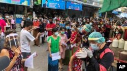 People stand in lines to get COVID-19 tests in Samut Sakhon, South of Bangkok, Thailand, Sunday, Dec. 20, 2020. Thailand reported more than 500 new coronavirus cases on Saturday, the highest daily tally in a country that had largely brought the pandemic u