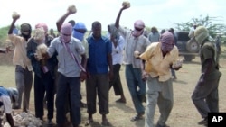 FILE - Participants of an execution by stoning are seen in Afgoye district, Somalia, Dec. 13, 2009. The al-Shabab militant group allegedly stoned to death a 44-year-old man in Rama Addey town in southern Somalia's Bay region, having found him guilty of adulter
