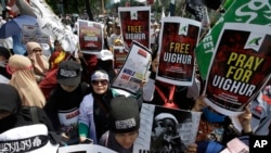 Muslim protesters rally outside China's embassy in Jakarta, Indonesia, Friday, Dec. 21, 2018. Several hundred protesters chanted "God is Great" and "Get out, communist!" outside China's embassy in the Indonesian capital.