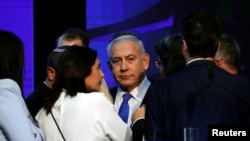 Israeli Prime Minister Benjamin Netanyahu looks on after speaking to supporters at his Likud party headquarters following the announcement of exit polls during Israel's parliamentary election in Tel Aviv, Sept. 18, 2019. 
