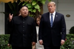 FILE - U.S. President Donald Trump and North Korean leader Kim Jong Un take a walk after their first meeting at the Sofitel Legend Metropole Hanoi hotel, in Hanoi, Vietnam, Feb. 28, 2019.