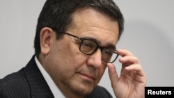 FILE - Mexican Economy Minister Ildefonso Guajardo gestures during a news conference in Mexico City, Mexico, May 8, 2017. 