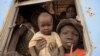 A South Sudanese family waits inside a train in Khartoum to be transported to Wau in South Sudan, March 1, 2012. Last week, 1,700 South Sudanese who lived at Kosti transit camp, south of Khartoum, returned home from the north. 