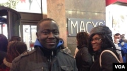 Emanuel Gomez, a shopper from Ghana has a game plan that includes photos of the items he aims to buy on his smartphone, outside Macy's Herald Square in New York on Thanksgiving, Nov. 28, 2013. (Photo Sandra Lemaire)
