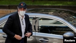 FILE - Michael Cohen arrives at his apartment after being released from prison to serve the rest of his sentence under home confinement, in New York, May 21, 2020. He was later jailed again but was rereleased to home confinement July 24.