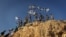 Children in the West Bank settlement of Itamar wave Israeli flags on a hilltop, Sept. 20, 2012. (VOA/Rebecca Collard)